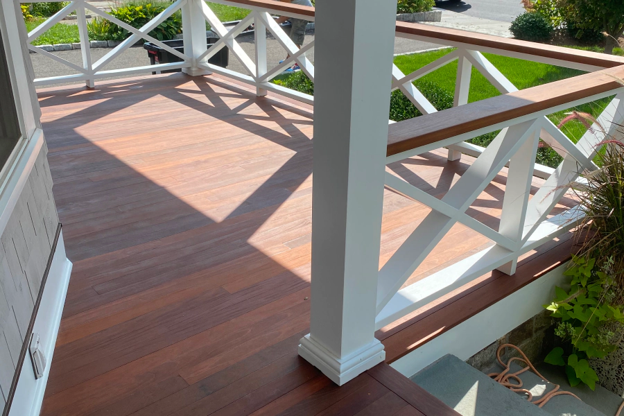 wood deck with some white frames of a beige house wood deck with some white frames of a beige house